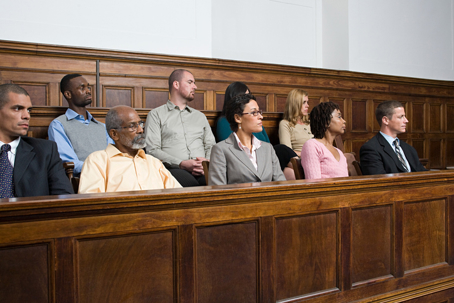 Diverse group of jurors seated in a New York courtroom jury box during a court trial hearing.
